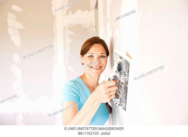 Woman sealing a wall