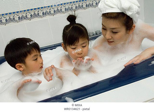 Mother and children taking bath