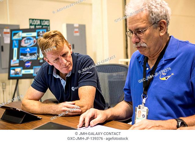 European Space Agency astronaut Timothy Peake (left), Expedition 4647 flight engineer, prepares for a training session in the Cupola trainer in the systems...