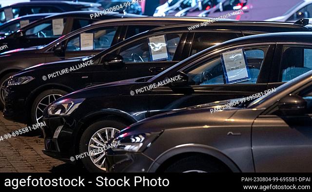 04 August 2023, Saxony-Anhalt, Wittenberg: New cars are parked on the premises of a Ford dealership in Wittenberg. The Federal Motor Transport Authority...