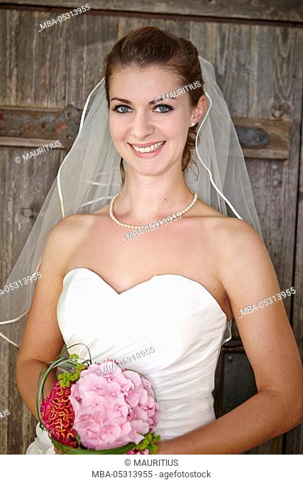 Bride with bridal bouquet in the hand