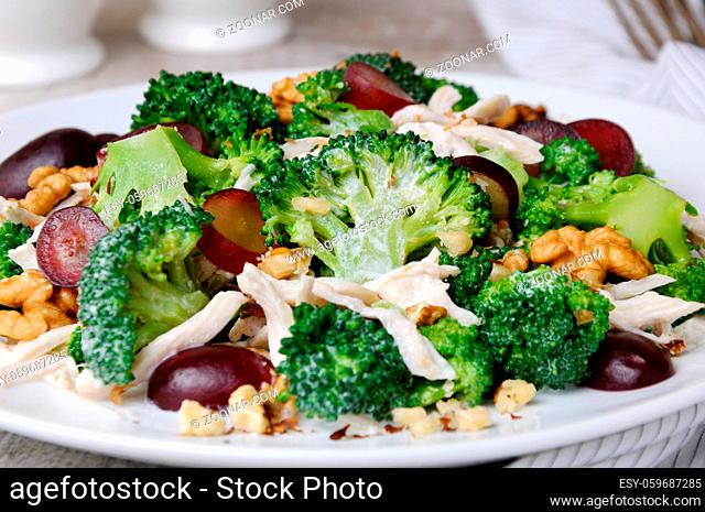 Dietary broccoli salad with chicken, sliced grapes, crushed nuts and yoghurt dressing