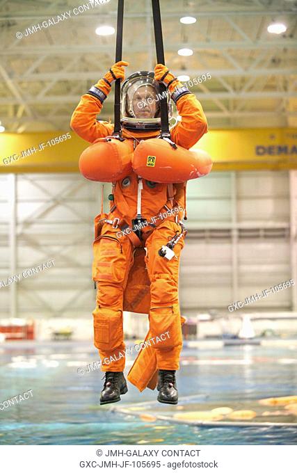 Astronaut Brent W. Jett Jr., STS-115 commander, attired in a training version of the shuttle launch and entry suit, simulates a parachute drop into water during...