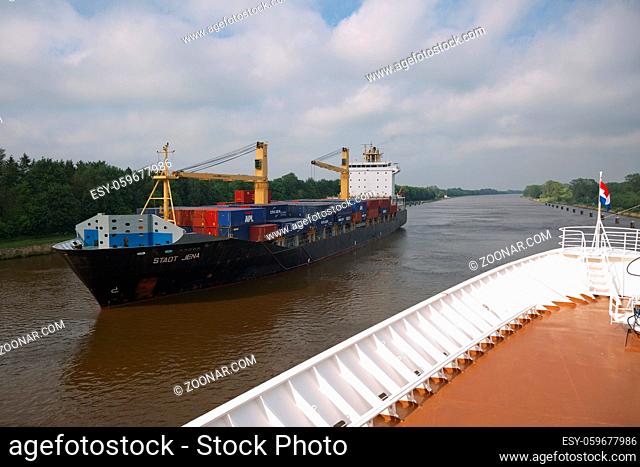 Kiel, Germany - May 23, 2017: Cruise ship and container boat passing by on Kiel canal in Germany