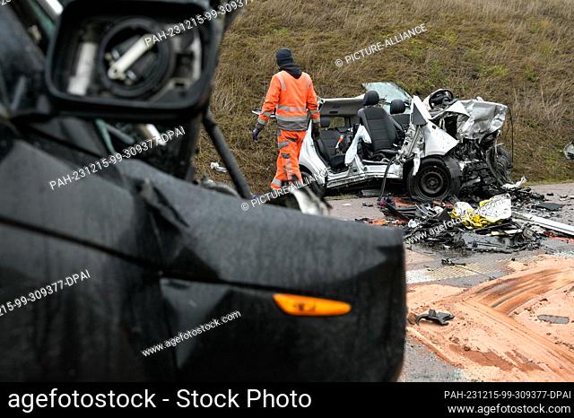 15 December 2023, Saxony-Anhalt, Querfurt: A car involved in the serious accident with a wrong-way driver on the A38 is being prepared for removal by a recovery...