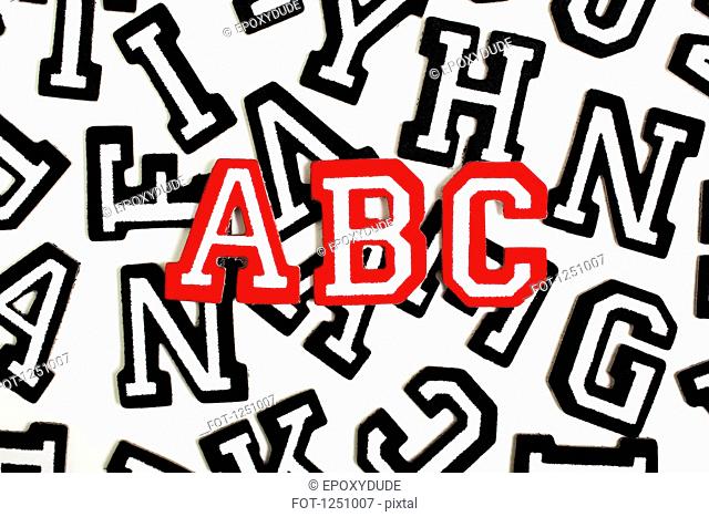 Red outlined varsity font stickers spelling ABC on top of black outlined letters