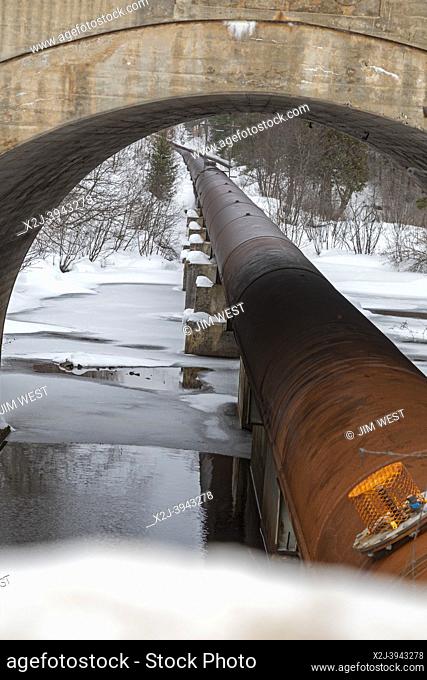 Au Train, Michigan - A hydroelectric power project operated by Renewable World Energies. A pipe carries water from the Forest Lake Dam to a power plant...