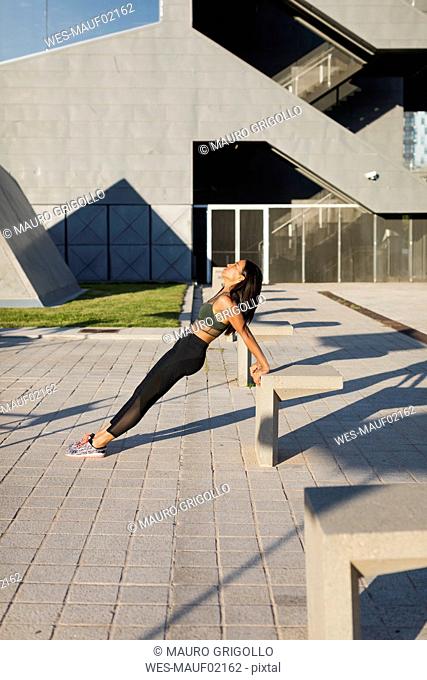Young woman doing workout exercise in the city