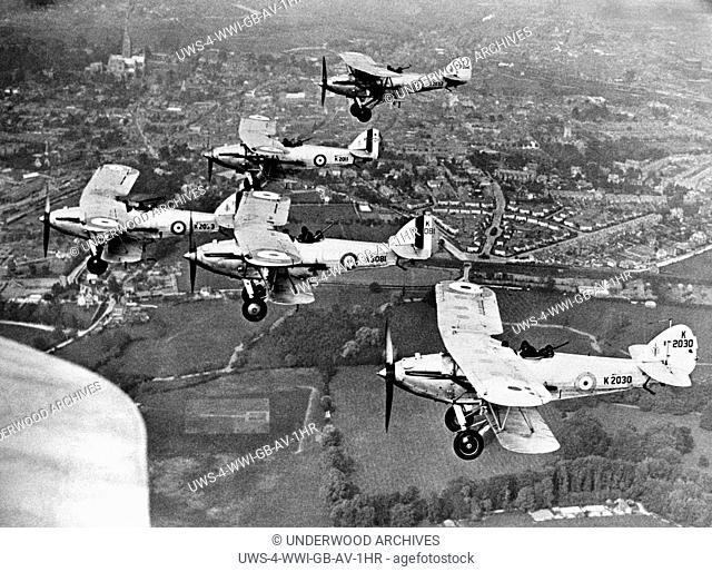 Salisbury, England: c. 1920.British airmen fly in formation at Old Sarum R.A.F. station in Salisbury for the Empire Day celebration to be held this year