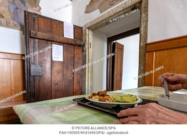 02 May 2019, Bavaria, Regensburg: A woman sits eating in the princely emergency kitchen at St. Emmeram Castle. In the emergency kitchen
