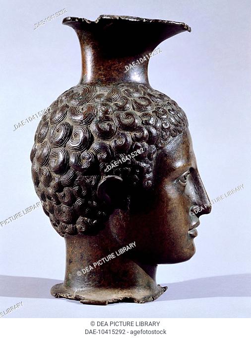 Bronze oinochoe in the shape of a young head, front view. Etruscan civilization, 375-350 BC.  Monaco, Staatliche Antikensammlung (State Collection Of...