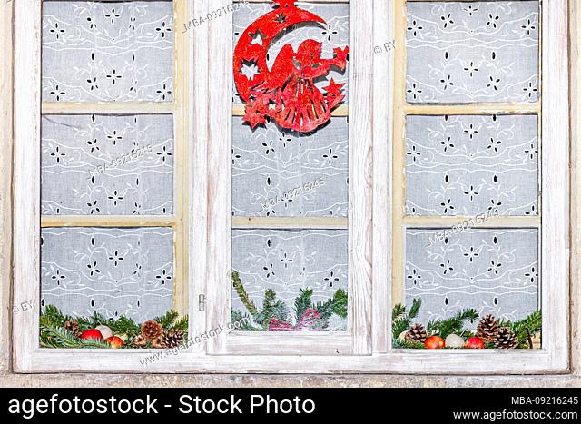 Christmas decoration on a window with curtain