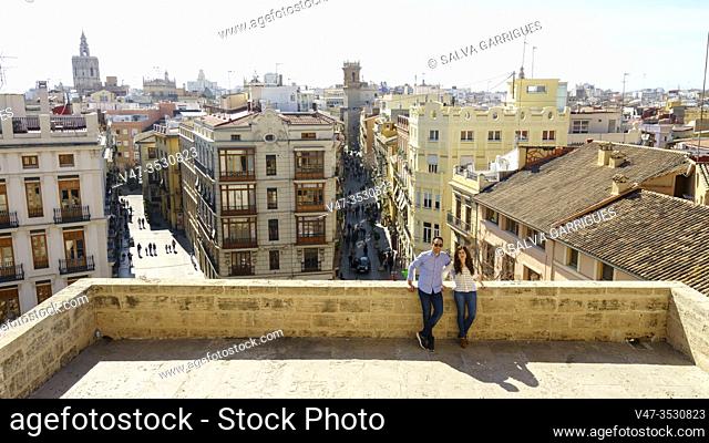 A wedding couple on the terrace of the Torres de Serrano, in the background the Micalet and the Carmen neighborhood, Valencia, Spain