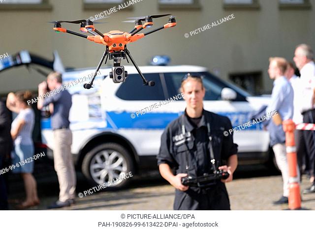 26 August 2019, Lower Saxony, Hanover: Sarah Buchholz, police commissioner and drone leader, flies a Yuneek 520 drone on the premises of the Central Police...