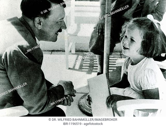 Adolf Hitler talking with a girl, historical photo circa 1937