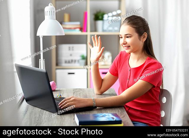 student girl with laptop having video call at home