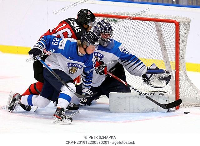 L-R Akil Thomas (CAN), Kim Nousiainen (FIN) and Justus Annunen (FIN) in action during a preliminary match between Canada and Finland prior to the 2020 IIHF...