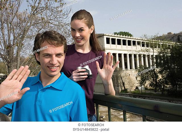 Couple at archaeological site waving