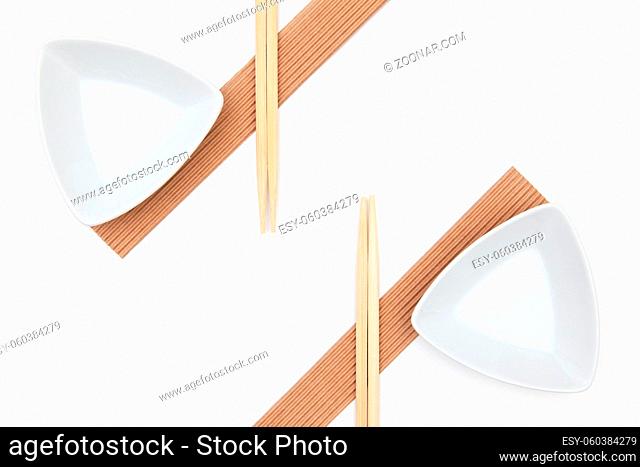 Top View Of White Empty Sushi Plates With Bamboo Chopsticks. Symmetry Food Design