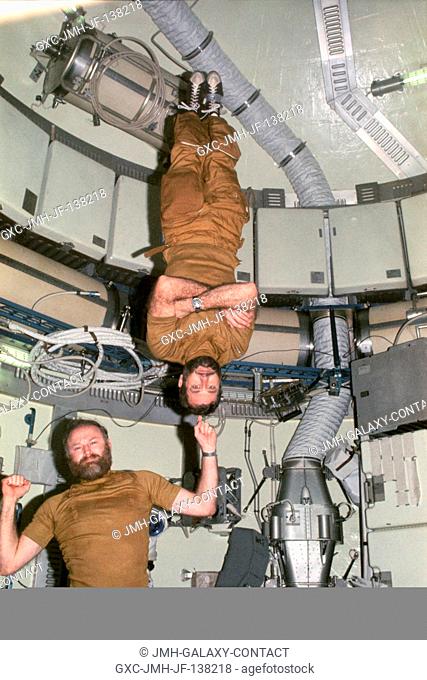 Two of the three Skylab 4 (third manning) astronauts exhibit the magic that can be accomplished in the weightlessness of space. Astronaut Gerald D