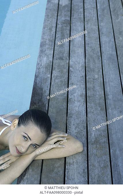Woman relaxing in pool, high angle view
