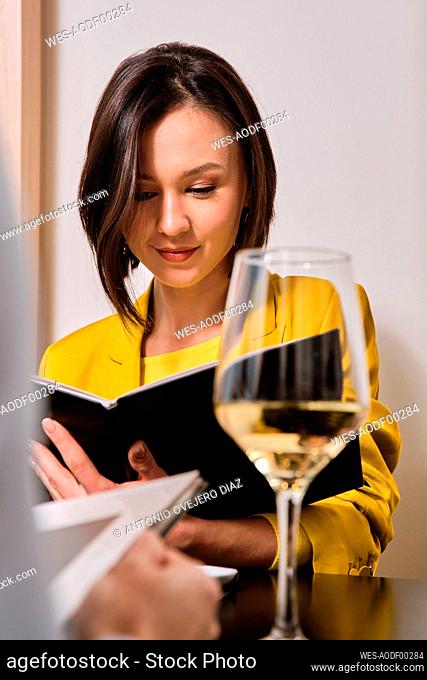 Young women with short hair reading restaurant menu