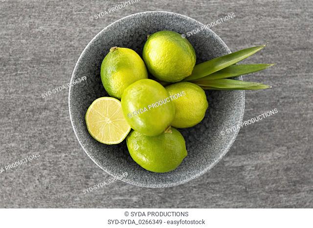 close up of whole limes in bowl