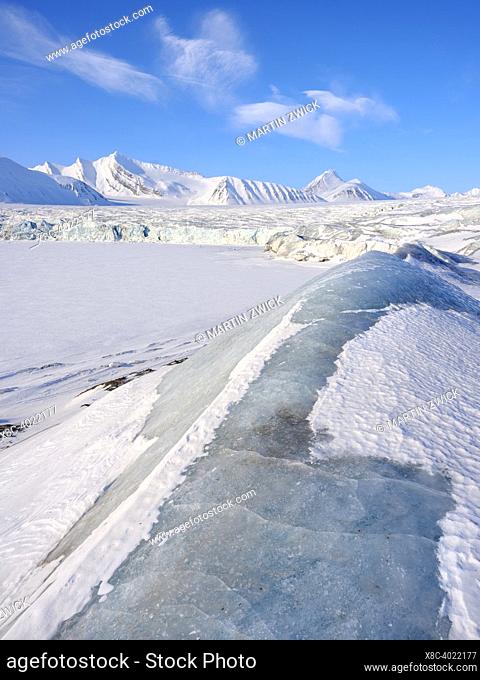 Glacier front of Fridtjovbreen and the frozen fjord Van Mijenfjorden. Landscape in Van Mijenfjorden National Park, (former Nordenskioeld NP)