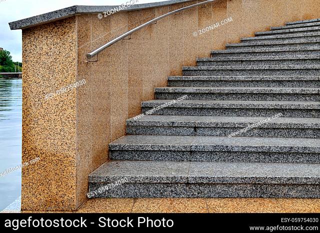 Staircase with marble steps and steel railings on the promenade