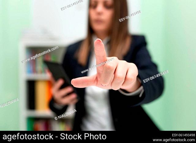 Businesswoman Holding Cellphone And Pointing New Ideas With One Finger