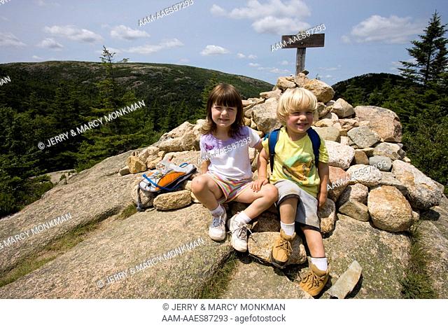 Two young hikers on the South Bubble in Acadia National Park Maine USA