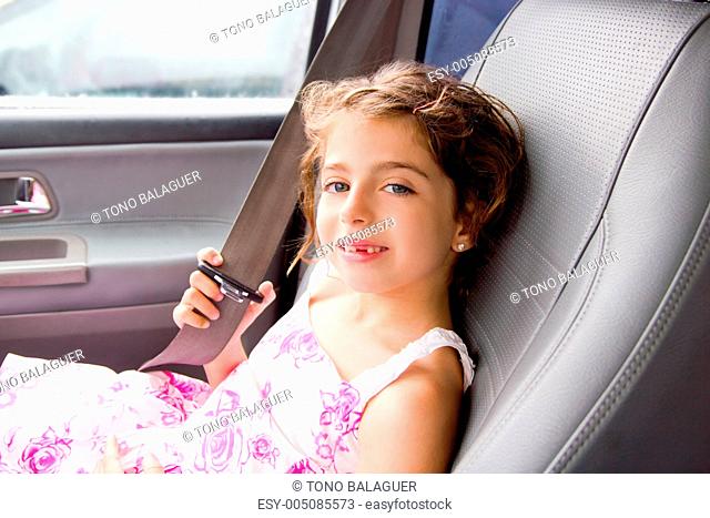 child little girl indoor car putting safety belt