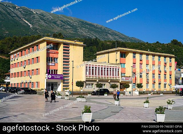 27 June 2020, Albania, Përmet: The City Hall of Permet (r) and the seat of an office of the Socialist Party of Albania (l