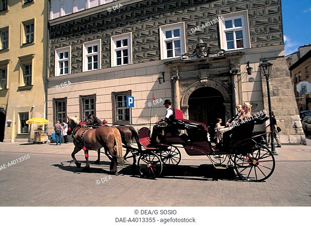 Poland - Malopolskie voivodship - Krakow Historic Centre (UNESCO World Heritage Site, 1978). Riding a horse-drawn carriage
