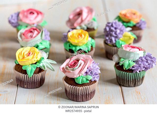 Chocolate cupcakes with cream-colored flowers