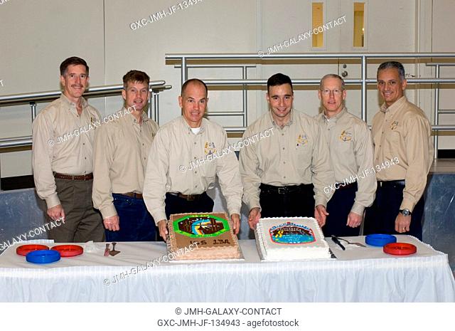 The STS-117 crewmembers celebrate the end of formal crew training with a cake-cutting ceremony in the Jake Garn Simulation and Training Facility at Johnson...