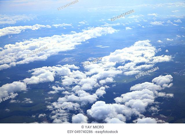Blue and silver clouds background, view from airplane
