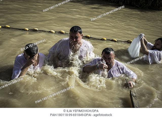 Orthodox Christian pilgrims immerse themselves in the waters of the Jordan River during the feast of the Epiphany at the West Bank baptismal site of Qasr el...