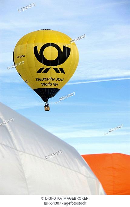 Floating black and yellow hot-air balloon, Montgolfiade Bad Wiessee, Bavaria, Germany