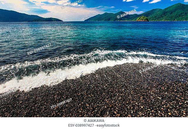 Beautiful crystal clear sea with black pebble beach at tropical island, Koh Lipe, Andaman sea, Thailand