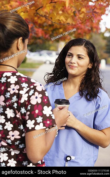 Young nurses talking outdoors