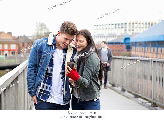 Young couple taking a selfie on a smartphone in the city