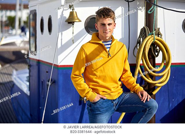 Young man in a fishing boat, Port De Plaisance Larraldenia, Ciboure, Aquitaine, Basque Country, France