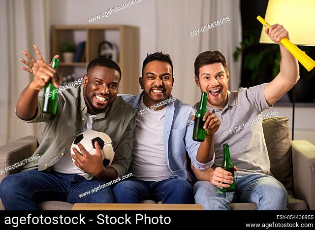 friends or soccer fans with ball and beer at home