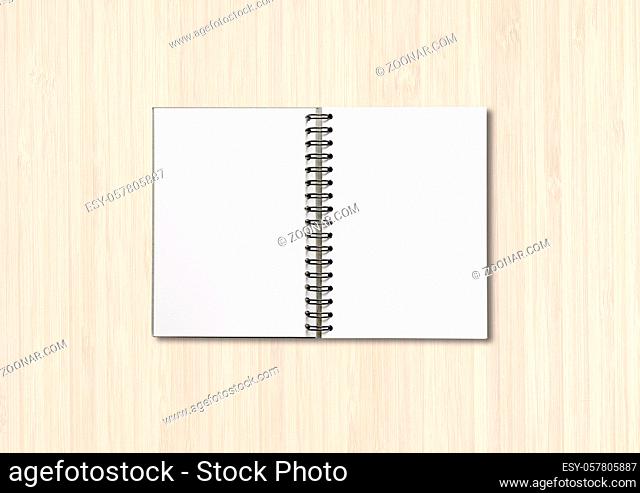 Blank open spiral notebook mockup isolated on white wood background