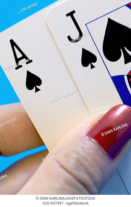 A woman's hand holding play-cards