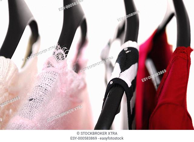 Women's clothing on a rack on black hangers