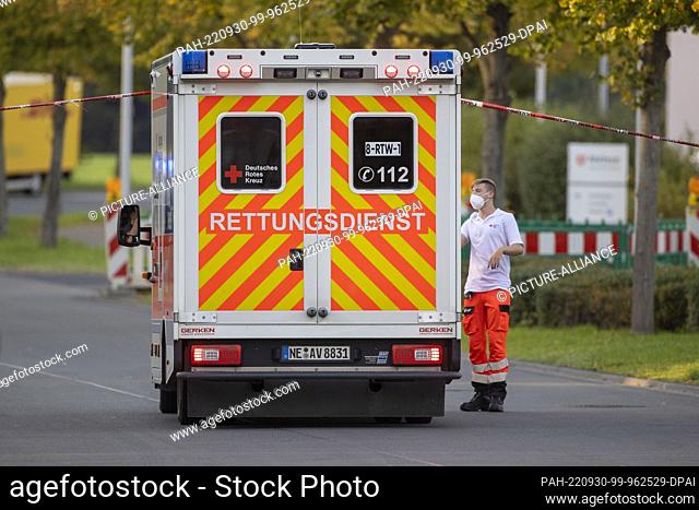 30 September 2022, North Rhine-Westphalia, Dormagen: An ambulance stands at the place where the police discovered a second man with a gunshot wound