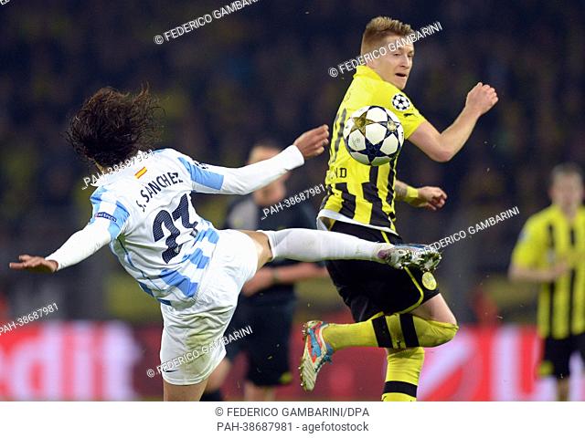 Dortmund's Marco Reus (R) and Malaga's Sergio Sanchez vie for the ball during the UEFA Champions League quarter final second leg soccer match between Borussia...
