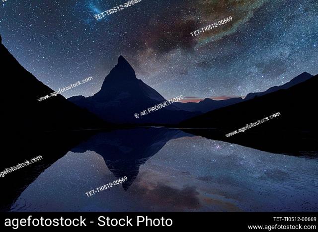 Switzerland, Canton Wallis, Zermatt, Matterhorn, Milky Way over Matterhorn reflecting in Riffelsee Lake
